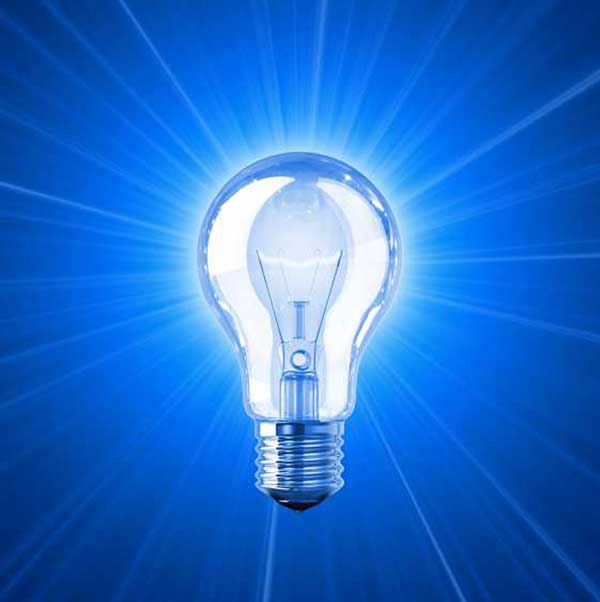 incandescent light bulb illuminating blue background rays extending