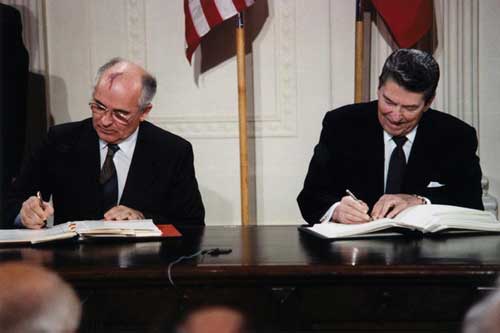 president reagan president gorbachev sitting signing treaty color