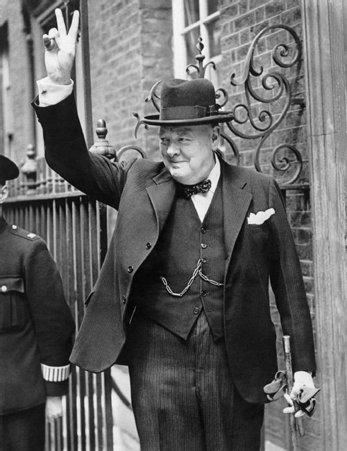 winston churchill prime minister black and white standing suit hat walking stick v for victory sign gesture