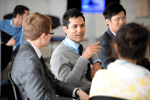 young men seated color students in conversation