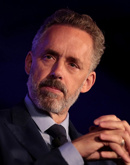 jordan_peterson_color_serious_hands_folded_via servetolead.com