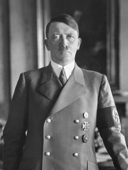 hitler chancellor black and white uniform official portrait standing iron cross