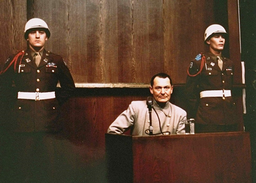 hermann_goering_seated_in_dock_nuremberg_trial_color_1945 via_servetolead.com